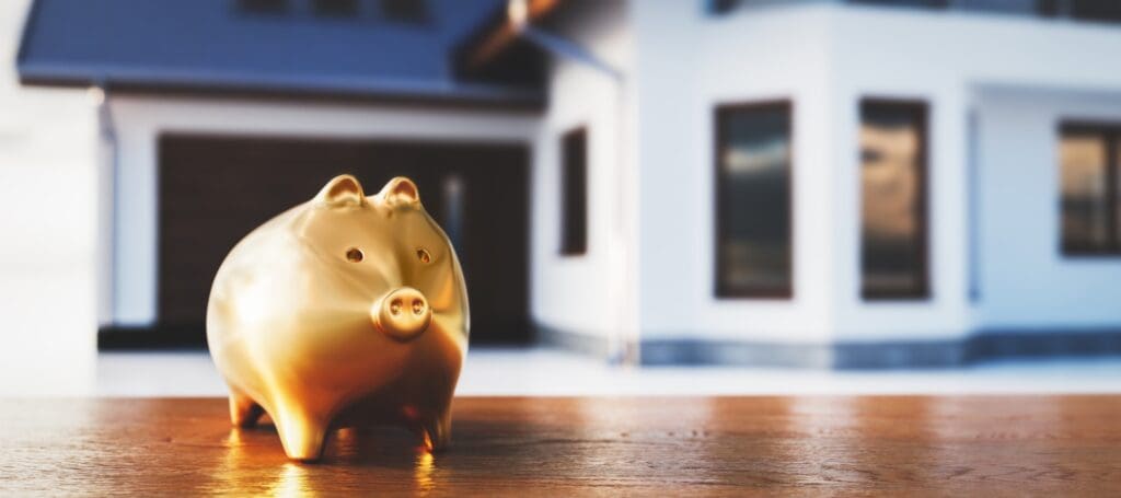 Piggybank and new house, saving for home, mortgage.
