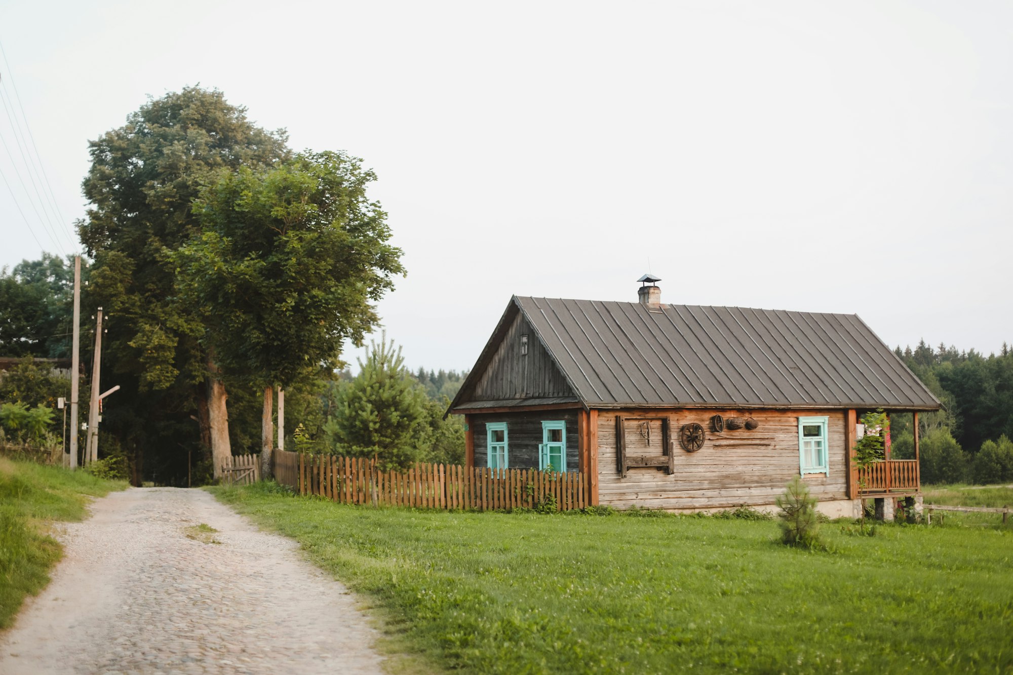 summer picturesque rural landscape with a wooden country farmhouse